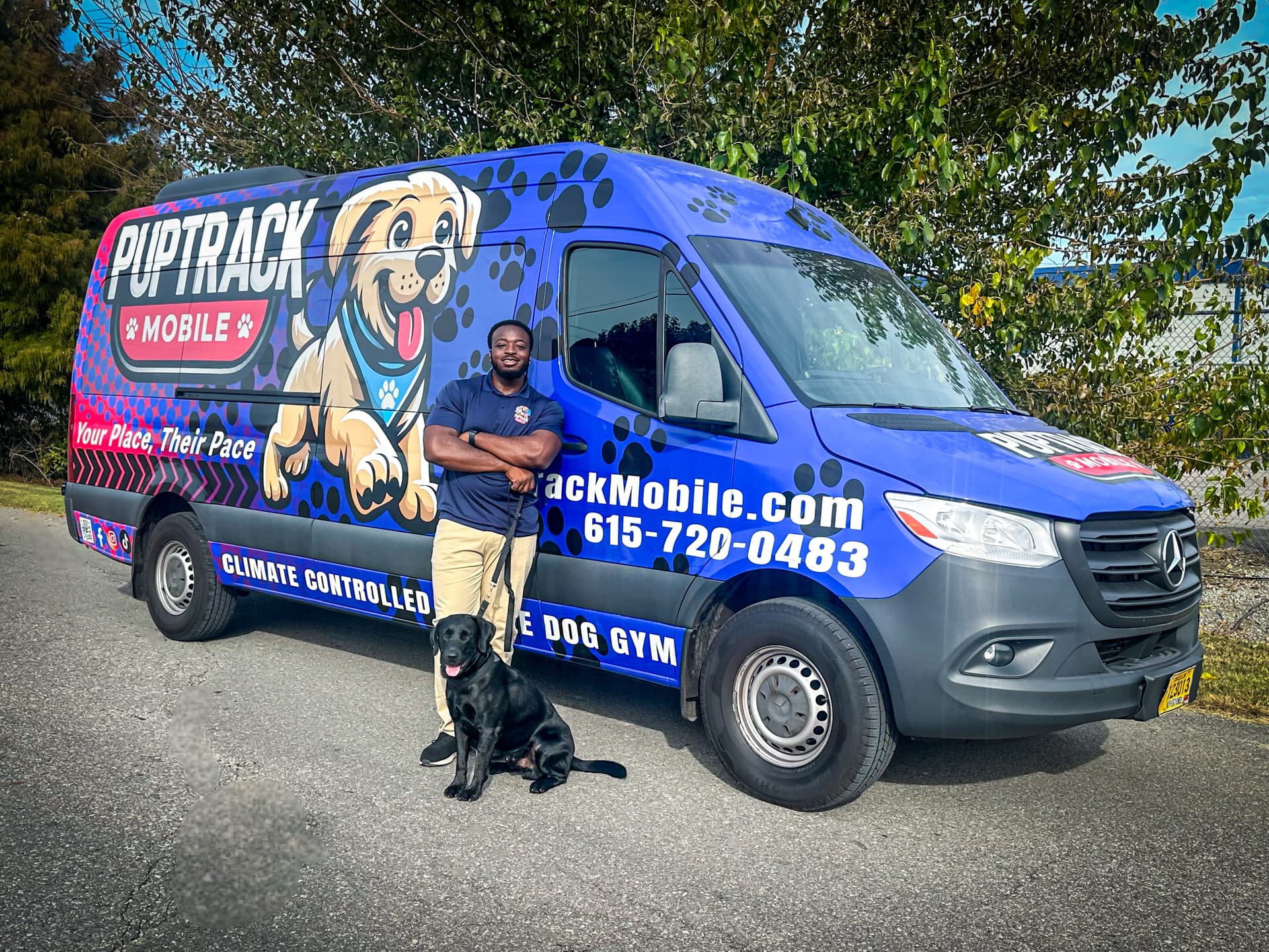 PupTrack Mobile Mercedes Sprinter van with owner and black lab